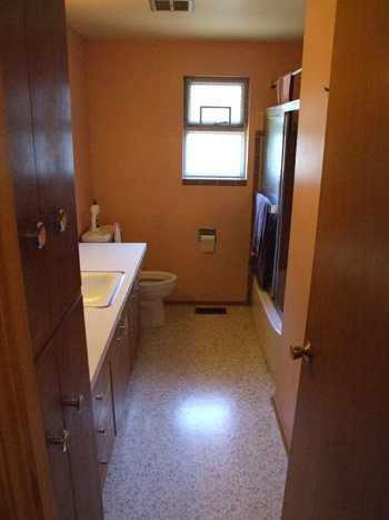 old bathroom with inaccessible tub, doorway, sink.